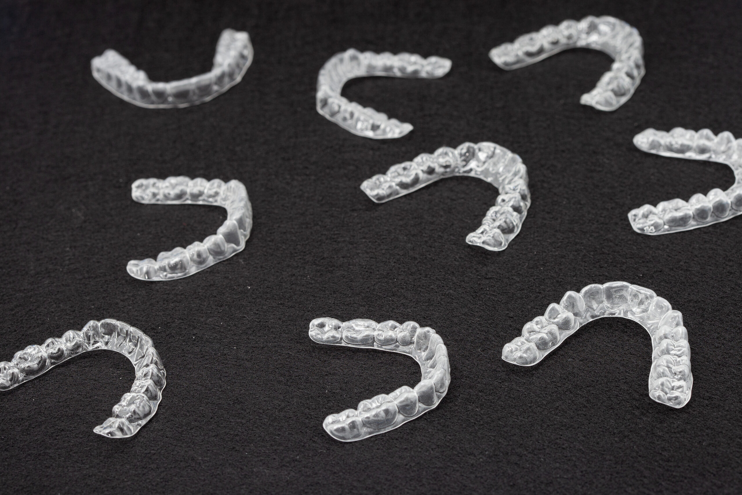 Transparent plastic mouth guard for teeth clenching. Grinding dental bite sleep aid. Dental care.